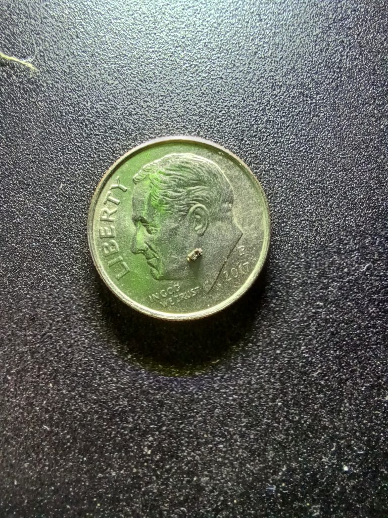 US Dime with the removed surface mount diode on it.